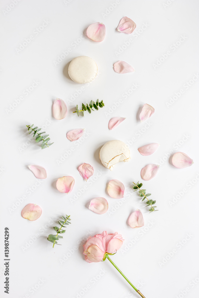 woman table with rose and macaroons in pastel color top view mockup