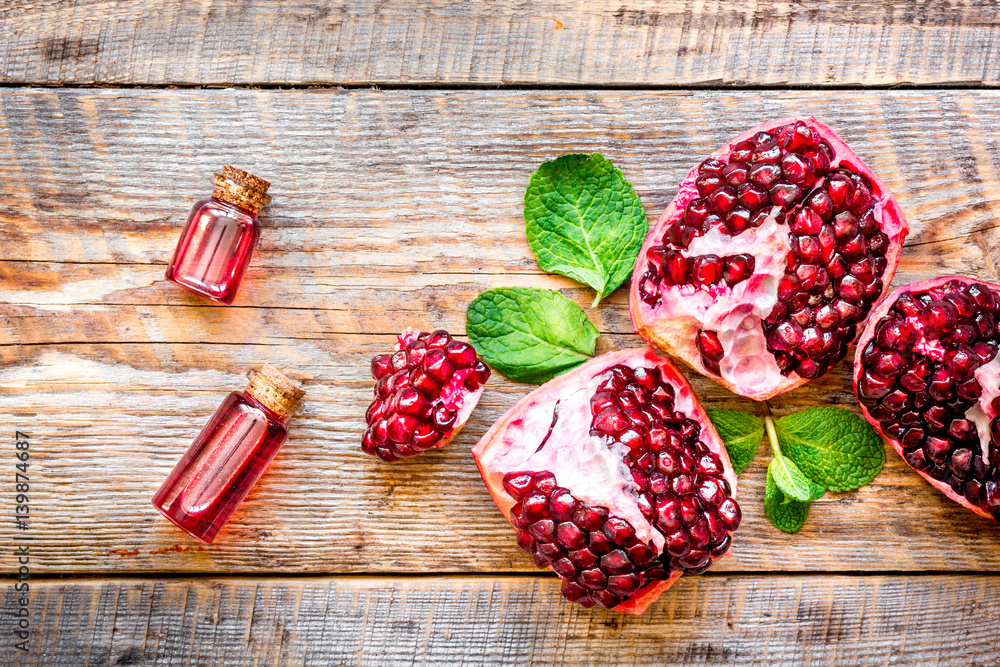 sliced pomegranate on wooden background top view