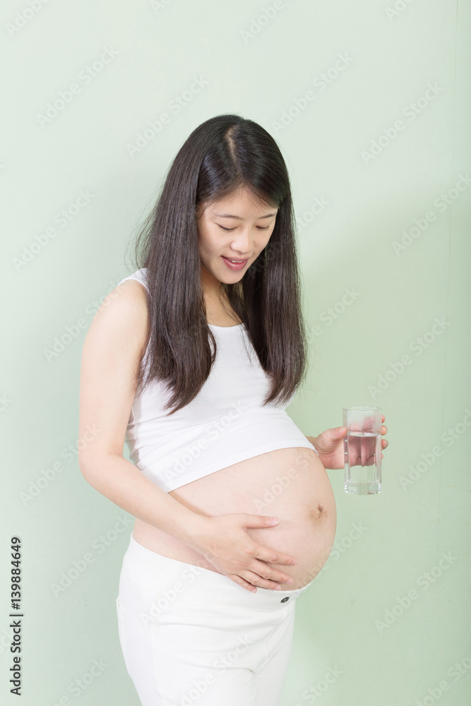 young pretty pregnant woman on background