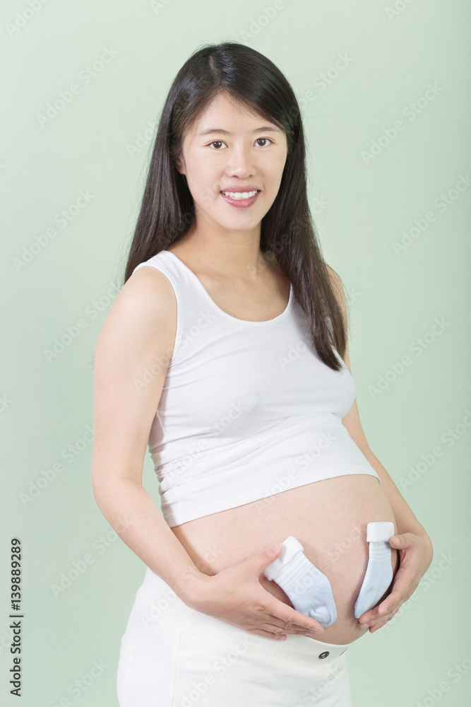 young pretty pregnant woman holds her bellly