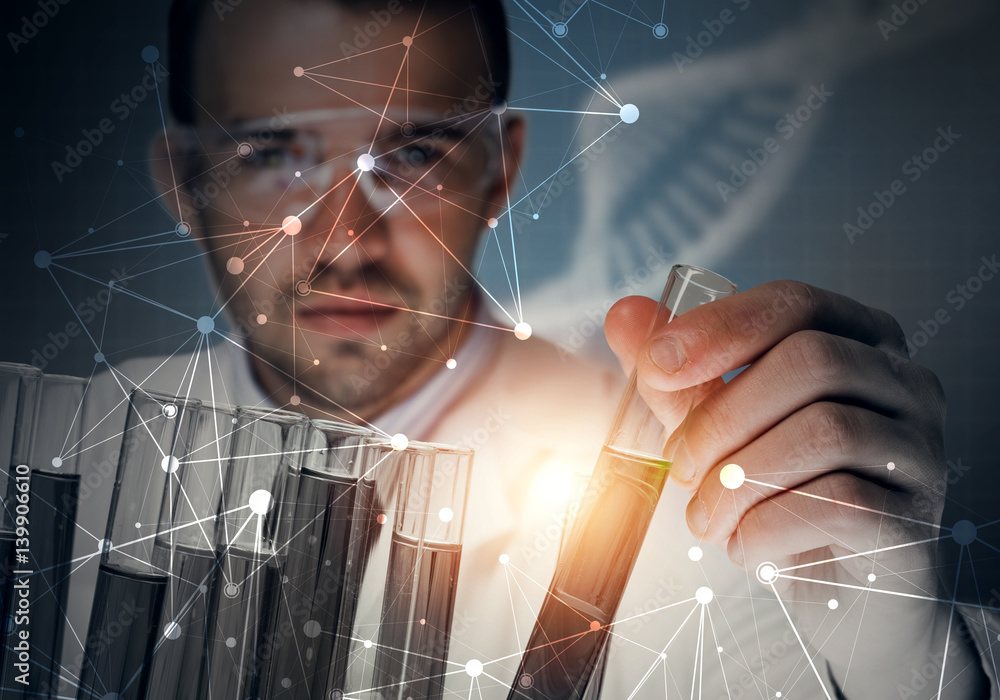 Portrait of concentrated male scientist working with reagents in laboratory