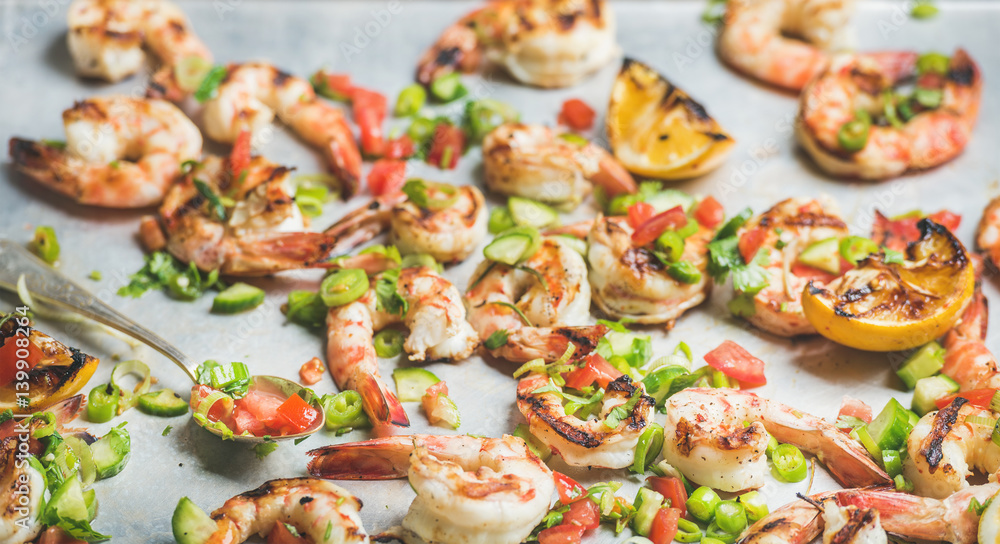 Seafood dinner. Close-up of grilled tiger prawns with leek, chili pepper, lemon and mint salsa sauce