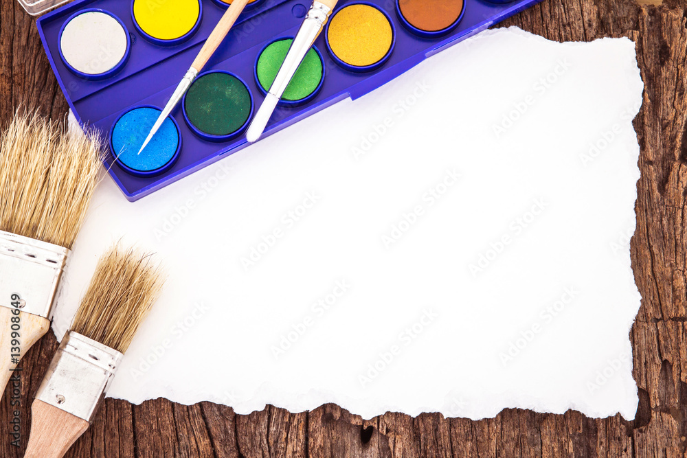 Art brush watercolor paint with white paper art  on wooden background