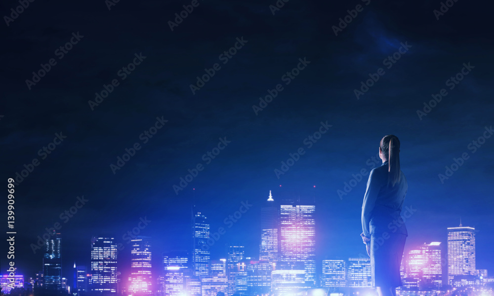 Woman looking at night city