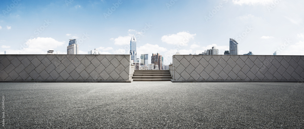 empty road and modern city in sunny day