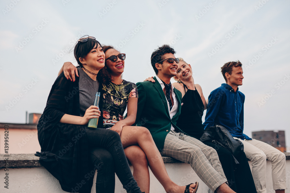 Friends hanging out together on rooftop