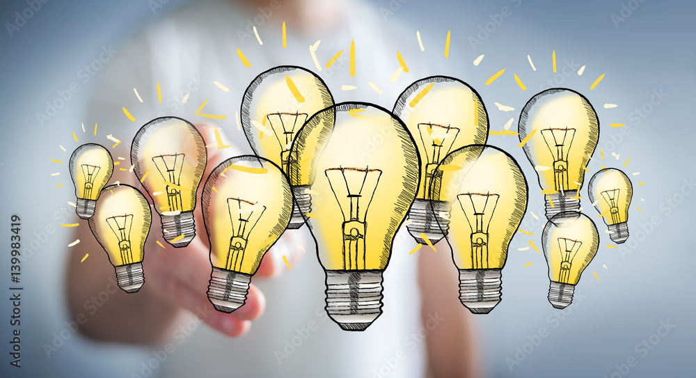 Businessman touching hand-drawn lightbulb with his finger