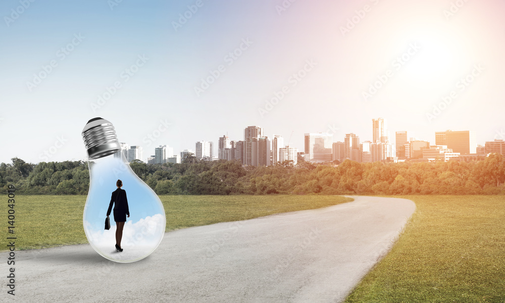 Businesswoman inside light bulb