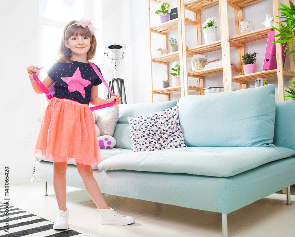 Happy little princess girl posing at home