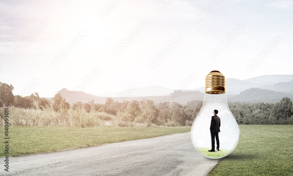 Businessman inside light bulb