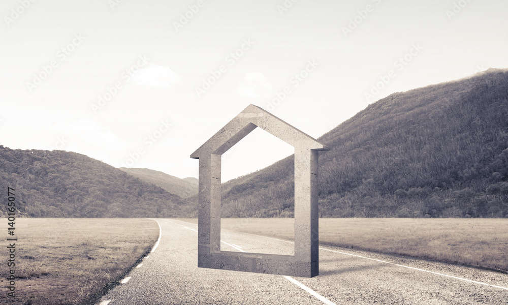 Conceptual background image of concrete home sign on asphalt roa