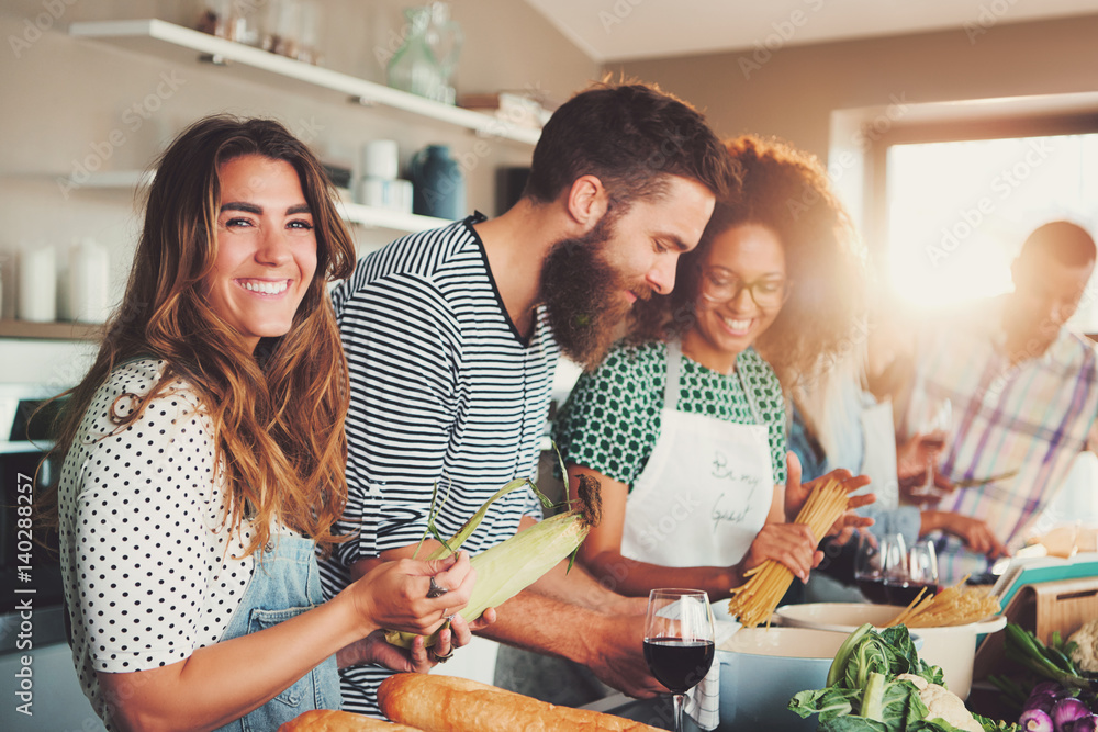 Multiracial friends cook tasteful food.