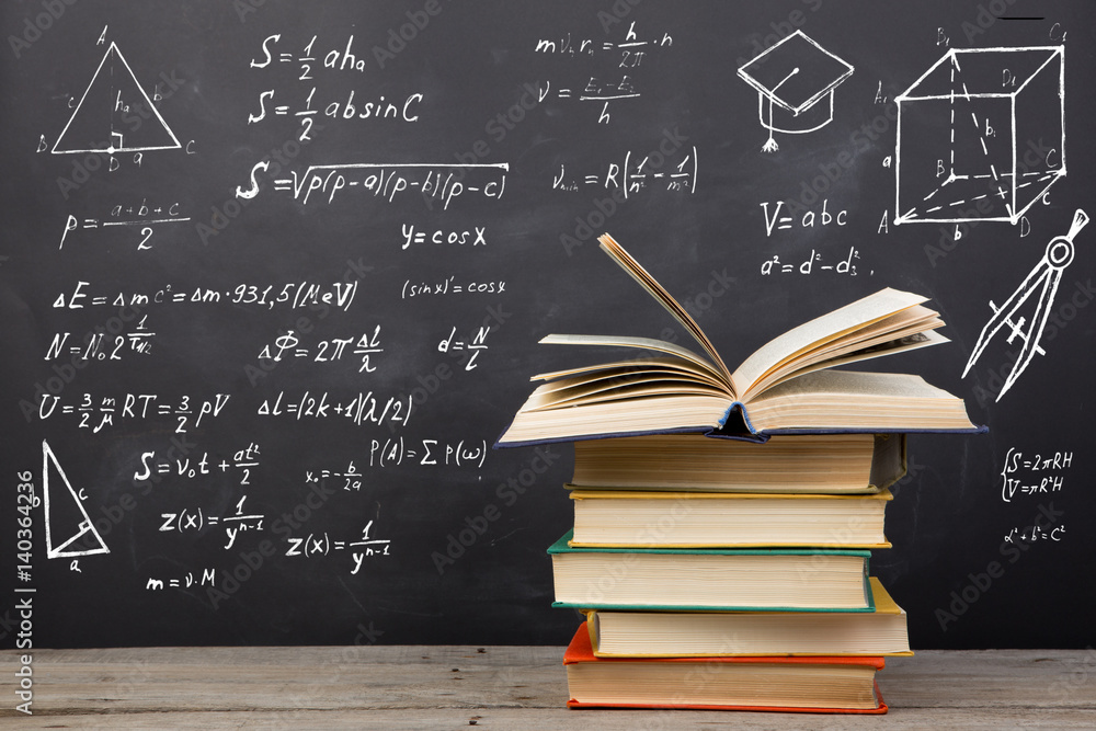 Education concept - books on the desk in the auditorium