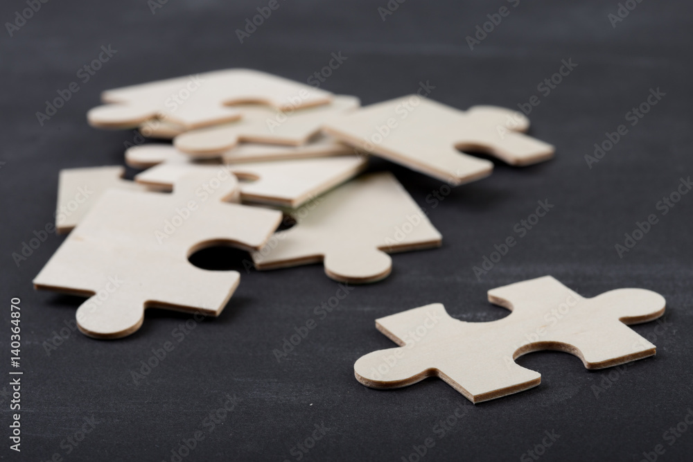 Leadership concept - jigsaw on the blackboard