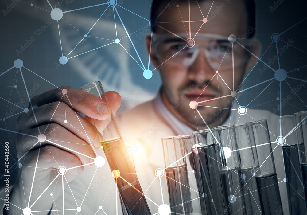 Portrait of concentrated male scientist working with reagents in laboratory