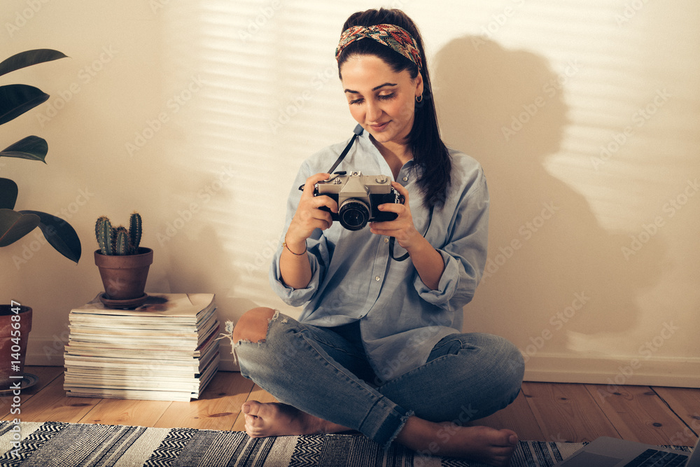 Pretty trendy young woman checking a photo