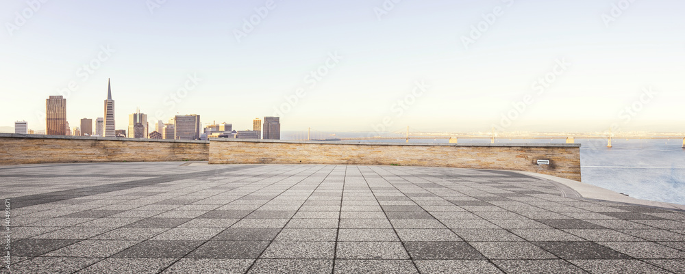 empty floor and modern city in sunny sky