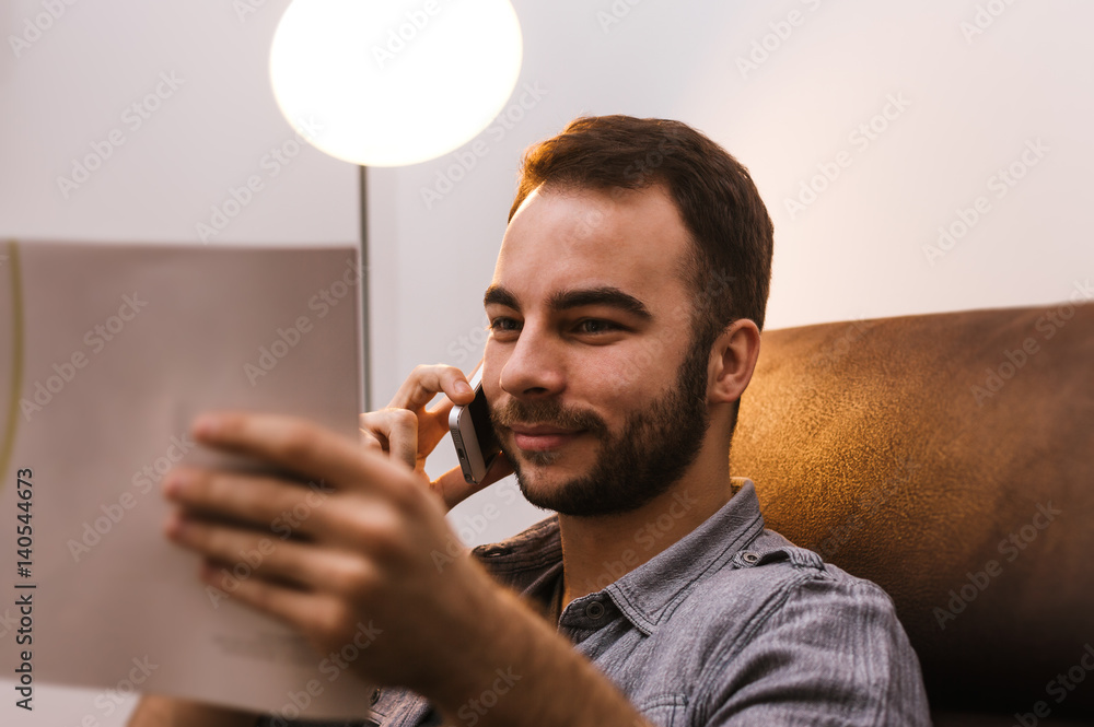 Businessman with magazine and phone