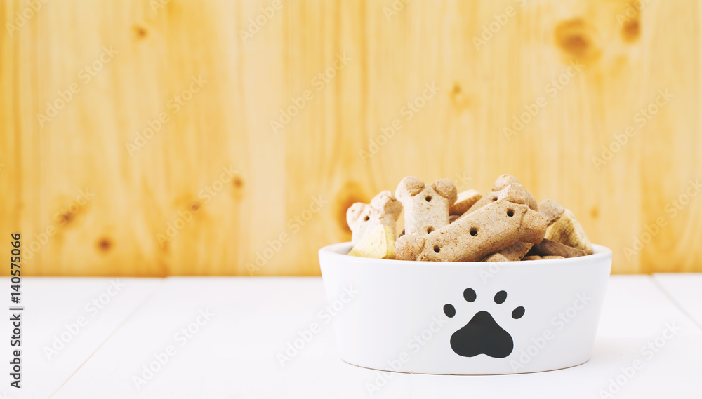 Dog treats in a bowl on wooden table