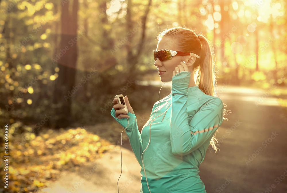 Runner in action at autumn under sunlight.