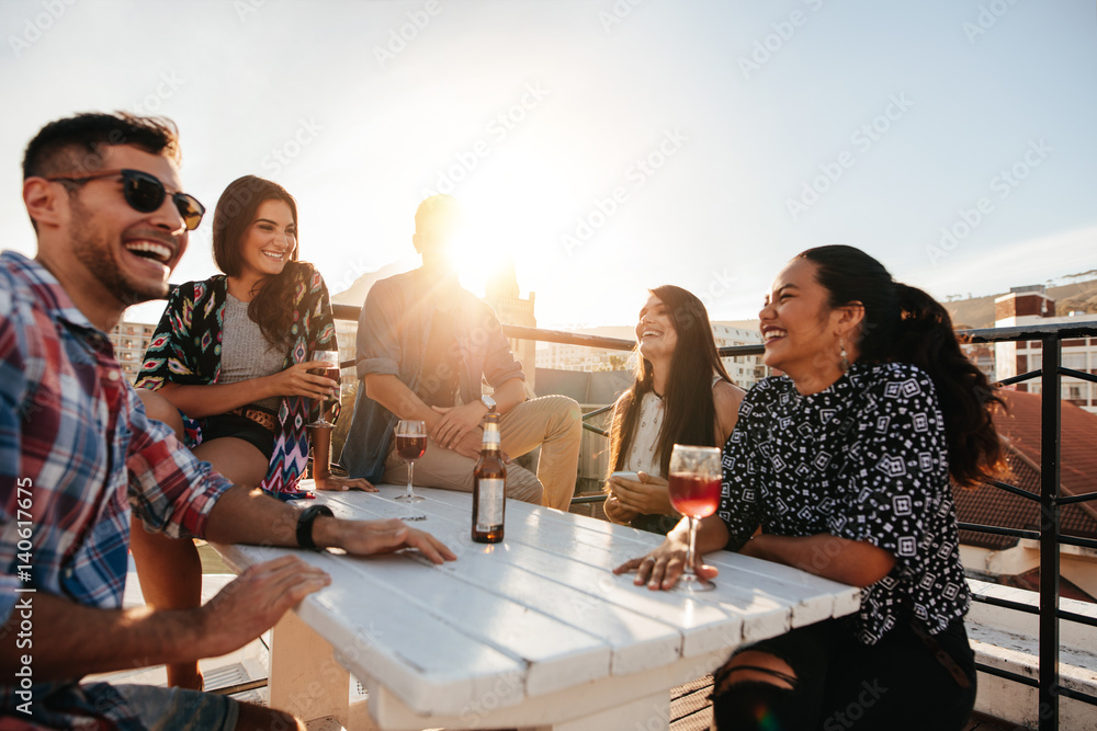 Happy young people having a rooftop party