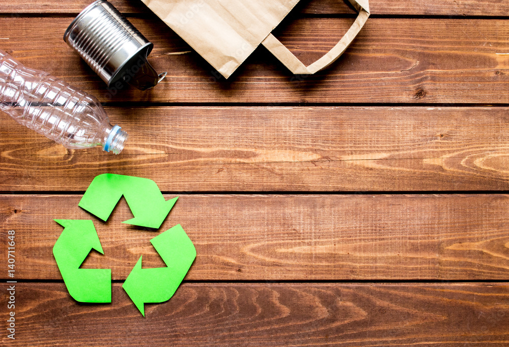 environment concept with recycling symbol on wooden background top view mock up