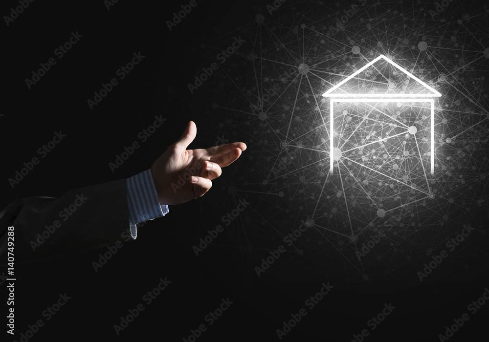 Conceptual image with hand pointing at house or main page icon on dark background