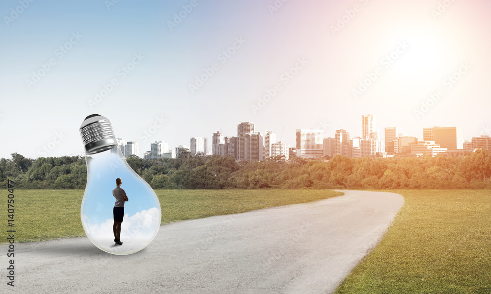 Businesswoman inside light bulb