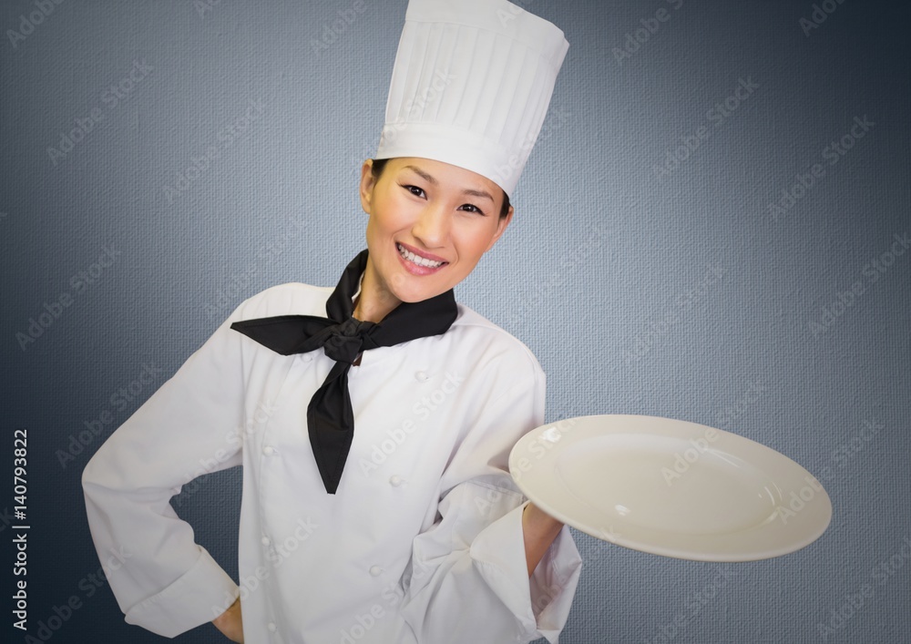 Chef with plate against grey background