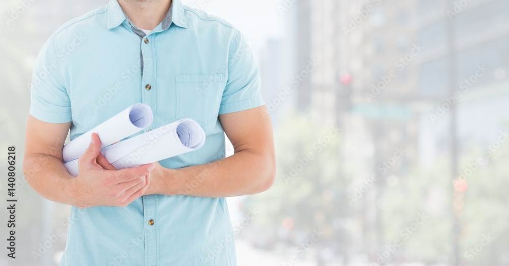 Composite image of Architect Torso holding plans