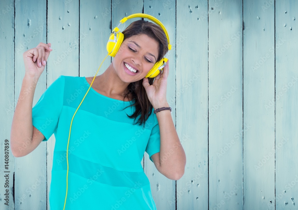 Composite image of Woman with headphones against blue wood panel