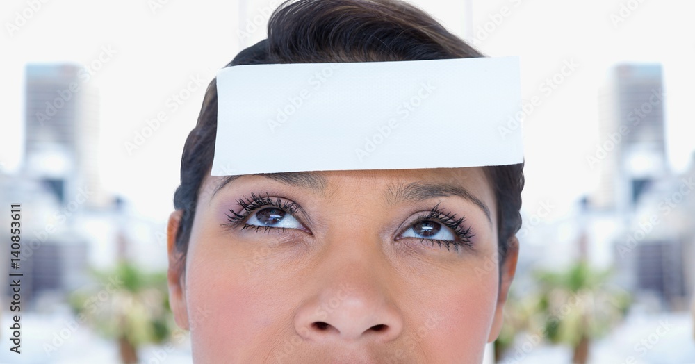 Woman with post it reminder note on forehead