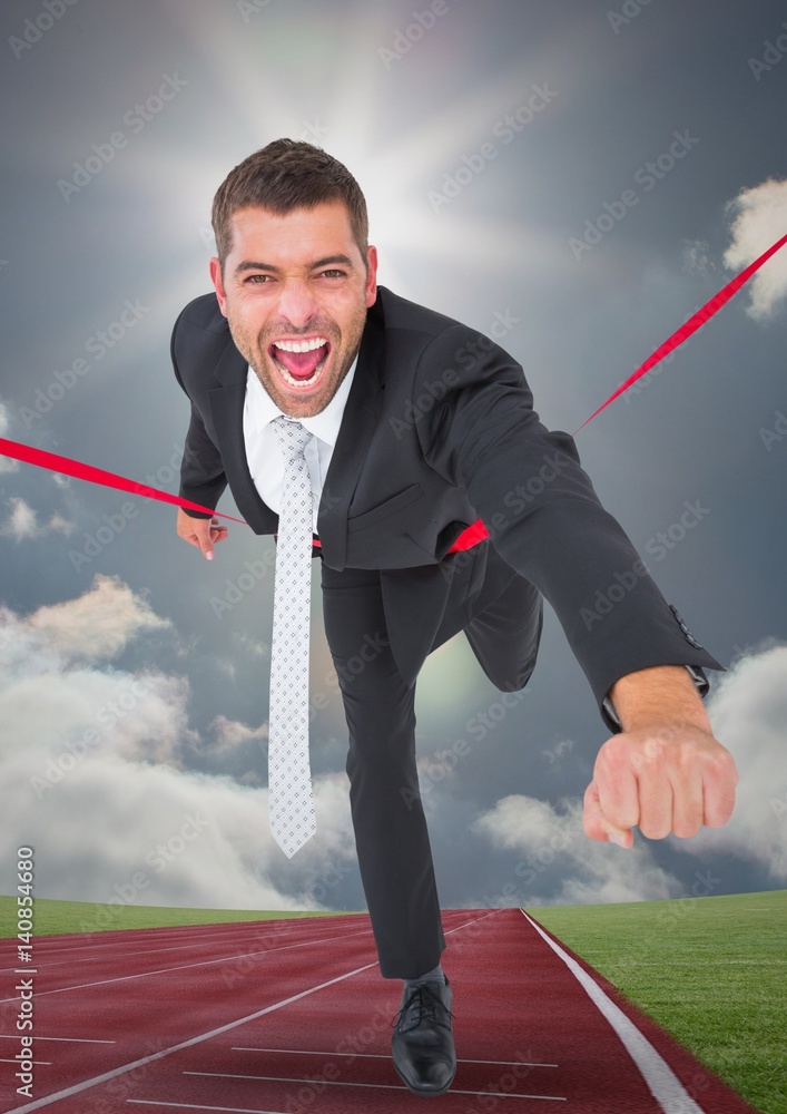 Businessman crossing finish line during race