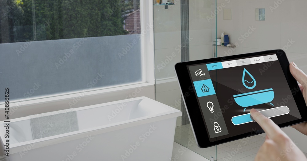 Hand holding digital tablet with home security icons on screen