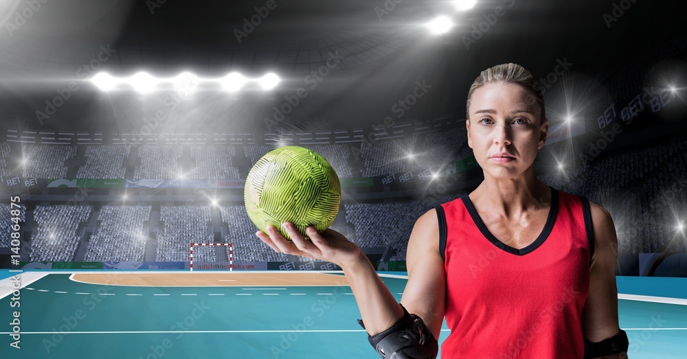 Athlete holding handball against stadium in background