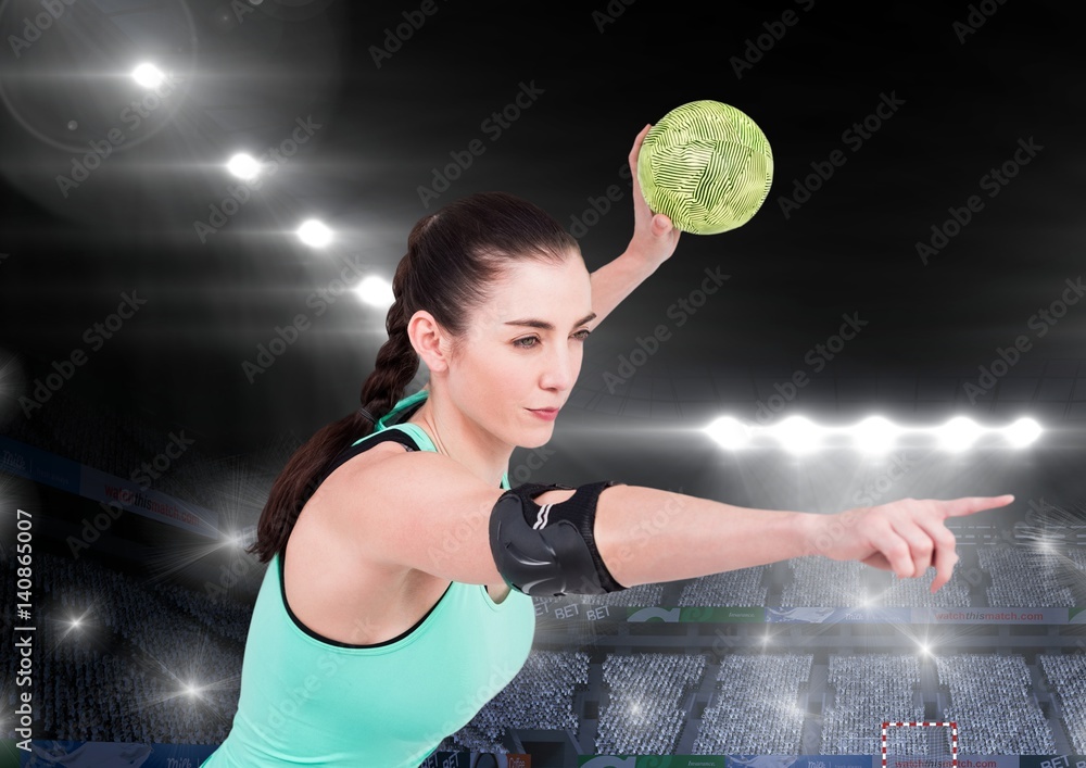 Athlete playing handball against stadium in background