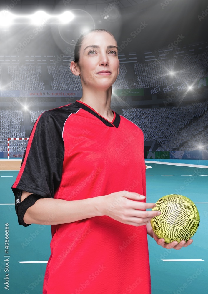 Female handball player holding ball at handball court