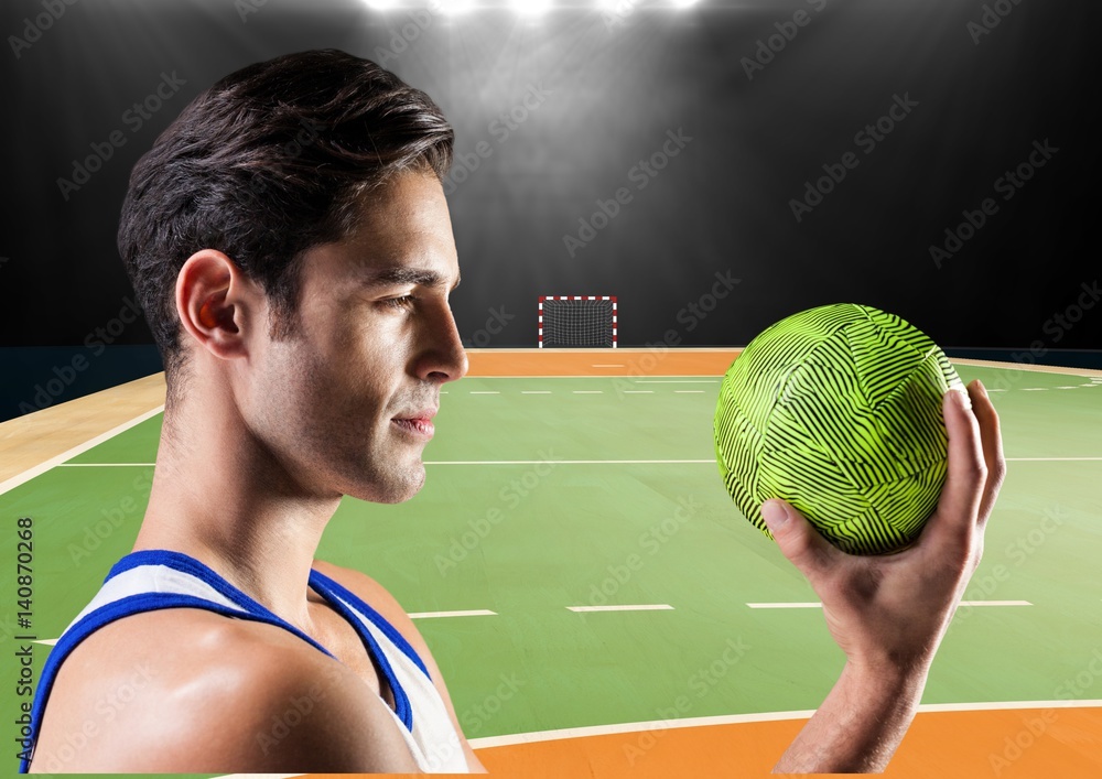 Focused player holding a handball in stadium