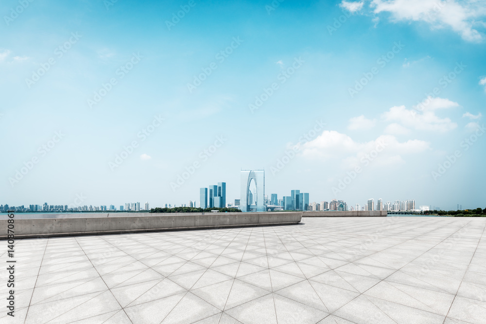 empty brick floor and cityscape of modern city