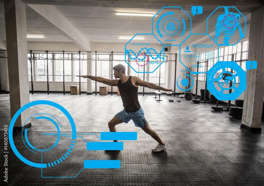 Fit man exercising in gym with  futuristic interface