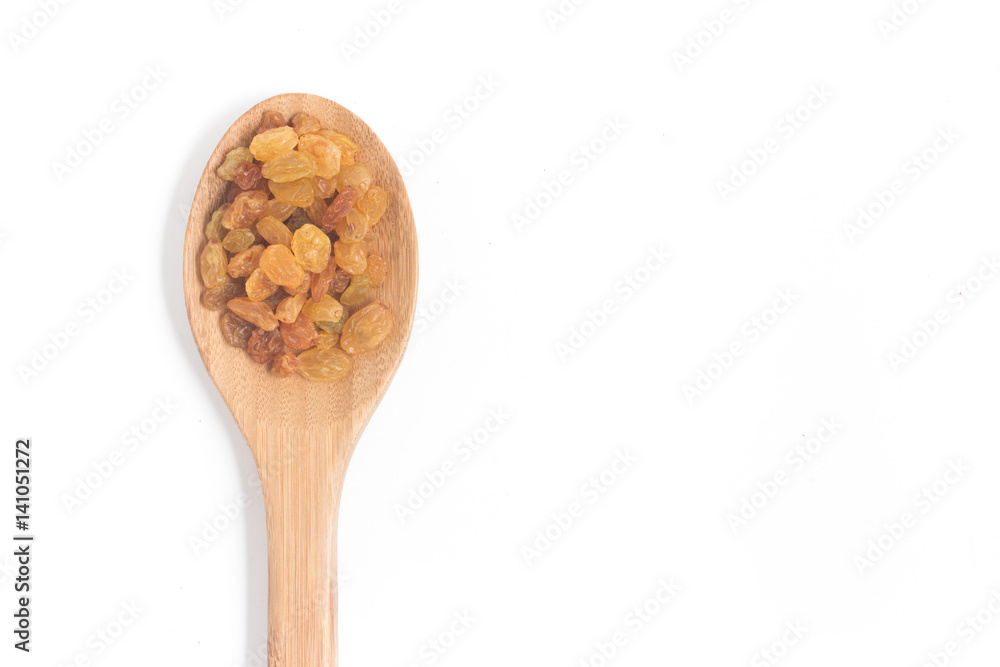 Raisins. Dried Grapes into a spoon