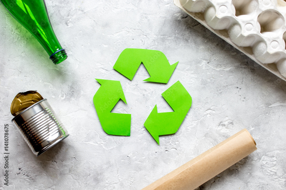 environment concept with recycling symbol on stone background top view