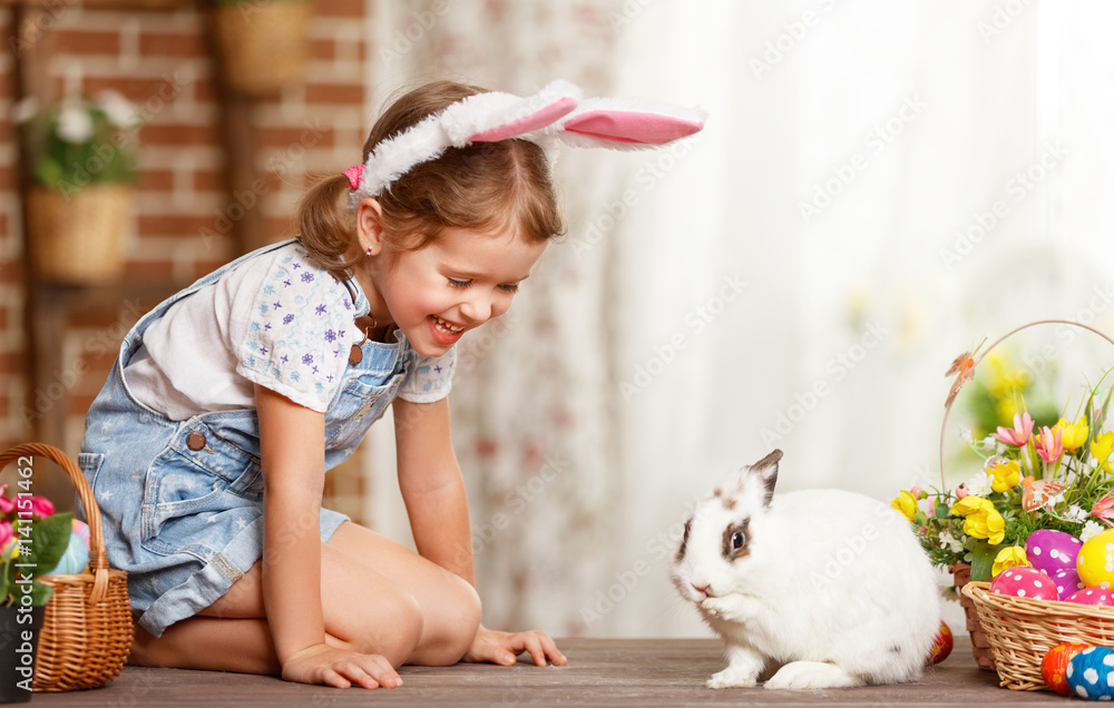 happy easter! happy funny child girl playing with bunny