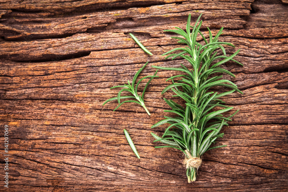 Fresh green Rosemary bound on a wooden board