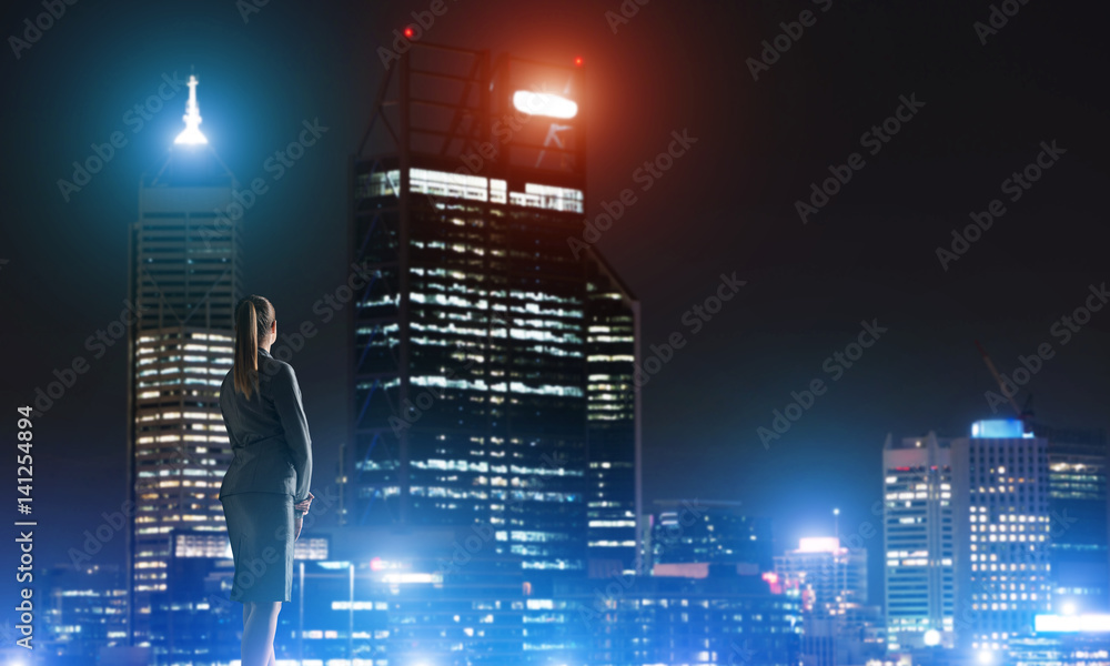 Woman looking at night city