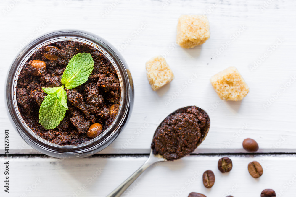 Organic scrub from ground coffee on table background top view