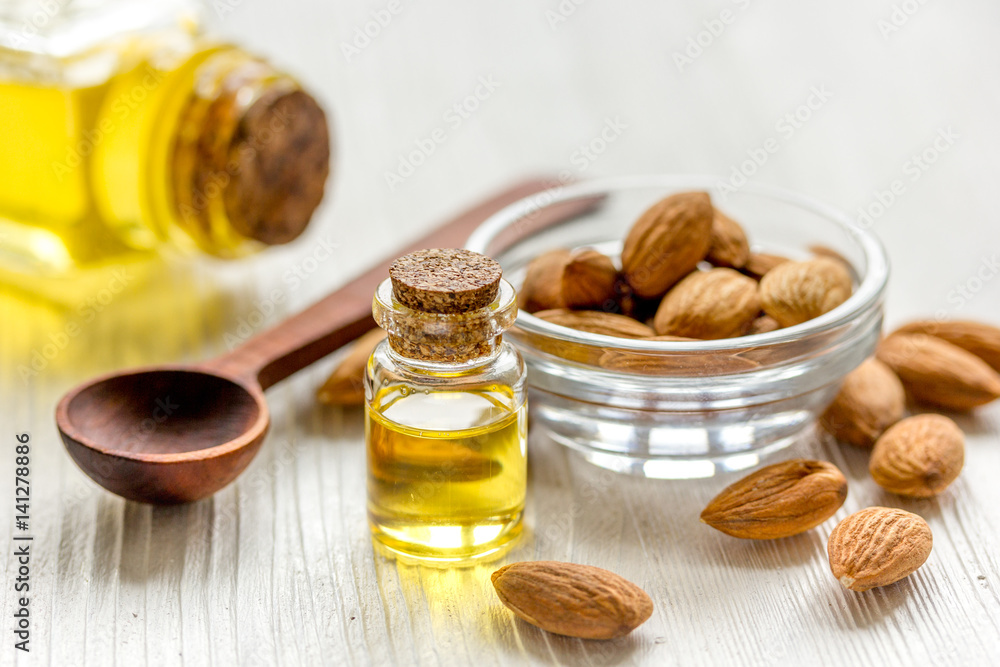 cosmetic set with almond oil on wooden table background