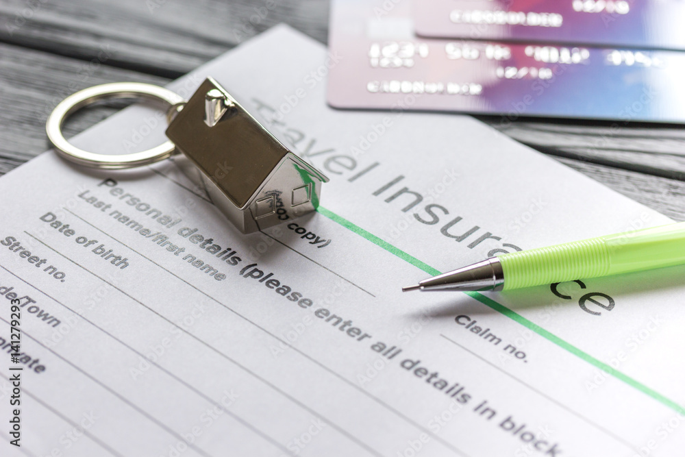 Traveling concept with insurance application on wooden table