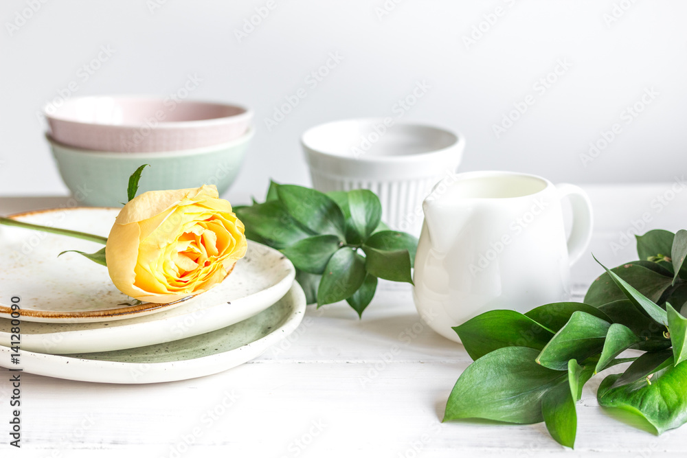 ceramic tableware with flowers on white background