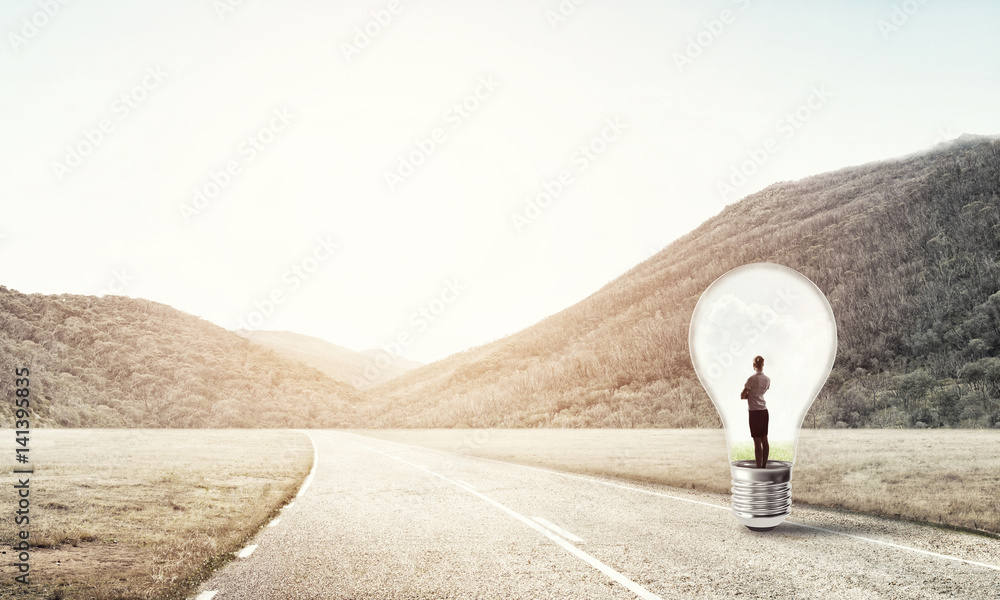 Businesswoman inside light bulb